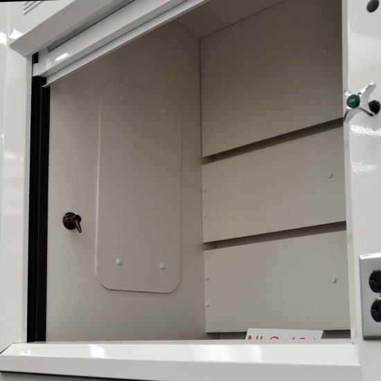 Interior angle showing the detail of a laboratory fume hood, model NLS-401, with a open sash window and a back baffle with slots for airflow, set against a light grey surface.