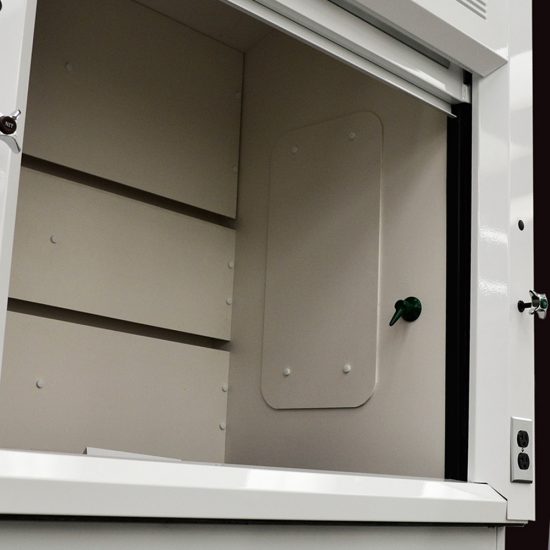 Interior angle showing the detail of a laboratory fume hood, model NLS-416, with a open sash window and a distinctive back baffle with slots for airflow, set against a light grey surface.