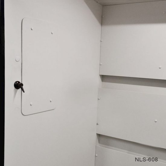 Close-up of a section of white laboratory furniture or equipment, labeled with "NLS-608" at the bottom right corner. There is a white panel with a black knob that appears to function as a door or an access hatch. The structure is assembled with rivets or bolts, as indicated by the numerous raised heads distributed evenly across the surface. The design is simple and functional, with clean lines and a professional appearance, typical of laboratory or medical-grade equipment. The photo's perspective does not reveal the entire apparatus, focusing instead on the detail of the panel and fastening elements.