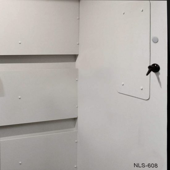 Close-up of a section of white laboratory furniture or equipment, labeled with "NLS-608" at the bottom right corner. There is a white panel with a black knob that appears to function as a door or an access hatch. The structure is assembled with rivets or bolts, as indicated by the numerous raised heads distributed evenly across the surface. The design is simple and functional, with clean lines and a professional appearance, typical of laboratory or medical-grade equipment. The photo's perspective does not reveal the entire apparatus, focusing instead on the detail of the panel and fastening elements.
