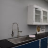 Blue laboratory cabinets with black epoxy work surface and sink.