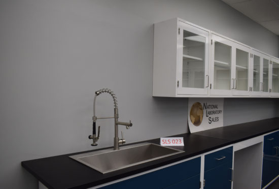 Blue laboratory cabinets with black epoxy work surface and sink.