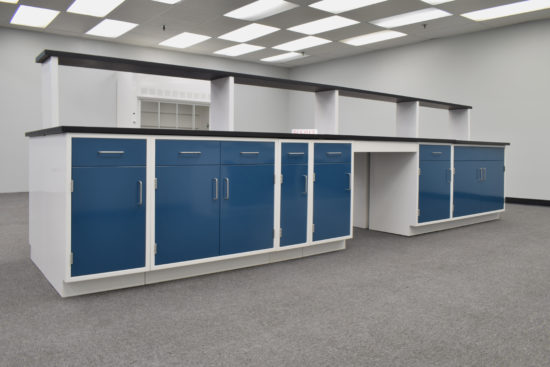 Laboratory island with desk area and center shelf.