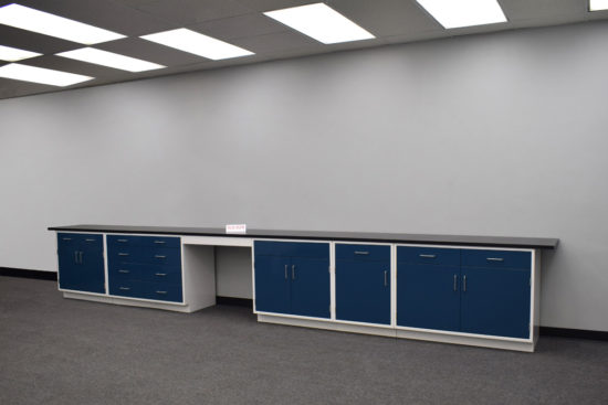 Blue laboratory cabinets with black epoxy work surface and desk.