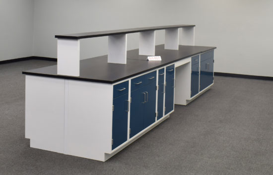 Laboratory island with desk area and center shelf.