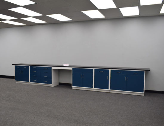 Blue laboratory cabinets with black epoxy work surface and desk.