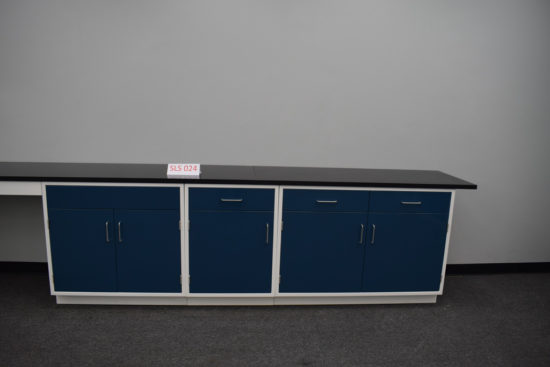 Blue laboratory cabinets with black epoxy work surface and desk.