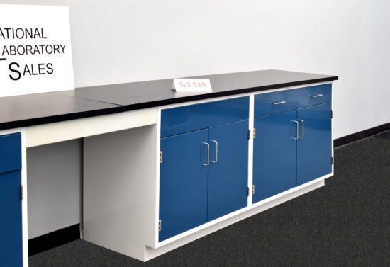 Blue laboratory cabinets with black epoxy work surface.