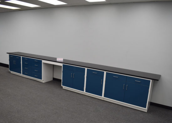 Blue laboratory cabinets with black epoxy work surface and desk.