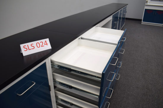 Blue laboratory cabinets with black epoxy work surface.