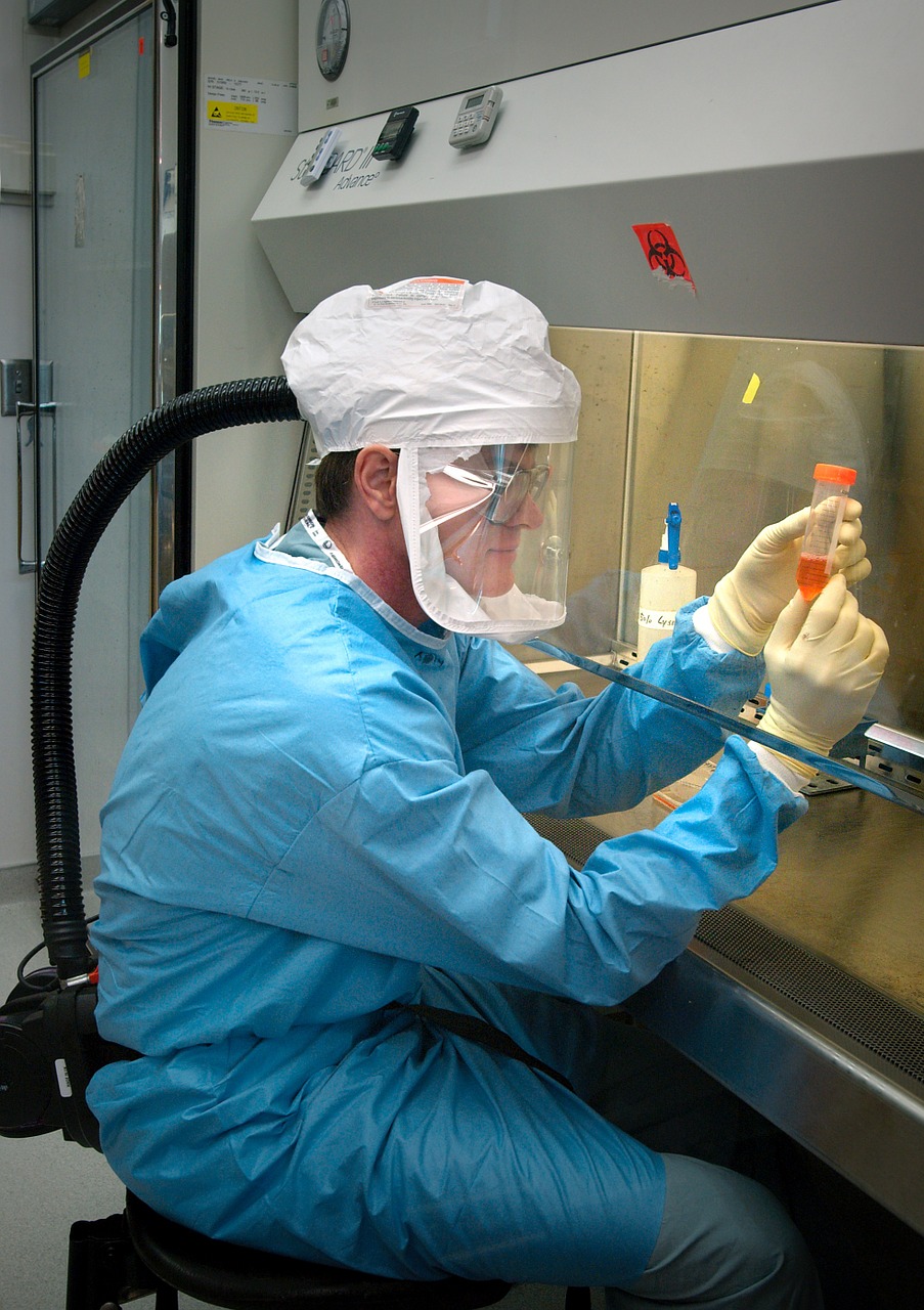 Microbiologist working in a fume hood.