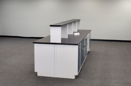 Laboratory island with desk area and center shelf.