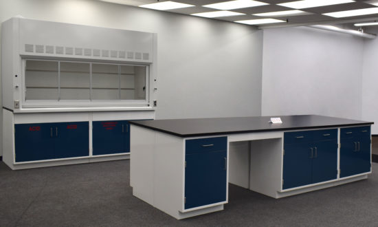 Laboratory island with desk area and black countertop.