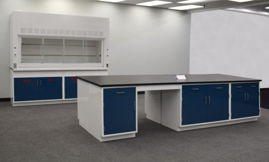 Laboratory island with desk area and black countertop.