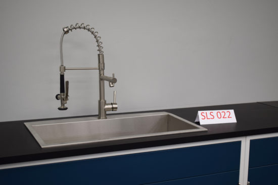 Blue laboratory cabinets with black countertops and sink.