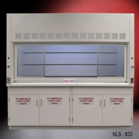 Laboratory fume hood, model NLS-833, manufactured by Fisher American. It features a work area with a wide viewing sash for easy access and visibility. Above the chamber are slats for air exhaust. Below the work area, there is cabinetry with double-door compartments labeled "FLAMMABLE KEEP FIRE AWAY," designed for safe storage of flammable materials.
