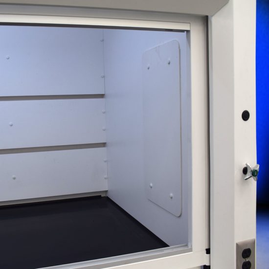 Inside view of model NLS-838, manufactured by Fisher American. It features a spacious work area with a wide viewing sash for easy access and visibility. Above the chamber are ventilation slats for effective air exhaust. Below the work area, there is cabinetry with blue double-door compartments labeled "FLAMMABLE KEEP FIRE AWAY," designed for safe storage of flammable materials. The fume hood has a robust build and is situated against a blue background.
