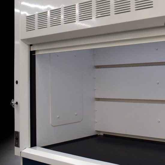 inside of a laboratory enclosure with a clear glass door, close-up of a section of white laboratory furniture or equipment