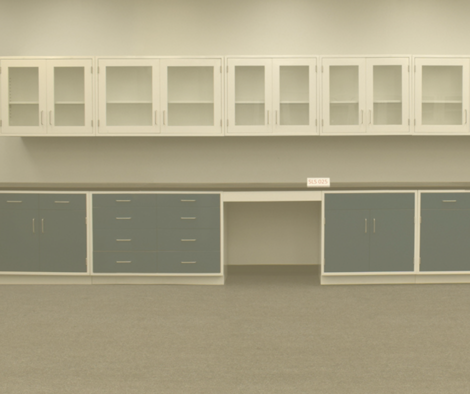 A modern laboratory casework setup featuring sleek blue base cabinets with stainless steel handles and white-framed upper cabinets with glass doors. The furniture is arranged along a clean, neutral-toned wall and floor, offering ample storage and workspace.